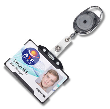 A retractable badge reel with a black and silver metal body, attached to a white plastic clip and a sample ID badge card. The reel is shown on a clean white background.