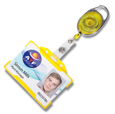 A retractable badge reel with a yellow and silver metal body, attached to a white plastic clip and a sample ID badge card. The reel is shown on a clean white background.