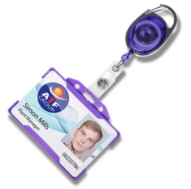 A retractable badge reel with a purple and silver metal body, attached to a white plastic clip and a sample ID badge card. The reel is shown on a clean white background.