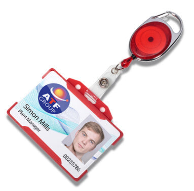 A retractable badge reel with a red and silver metal body, attached to a white plastic clip and a sample ID badge card. The reel is shown on a clean white background.